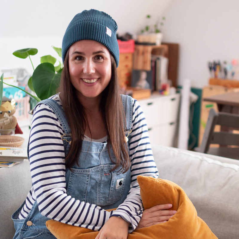 Sarah Gilgien trägt die Fisherman Beanie Kleiner Regenbogen in der Farbe petrol